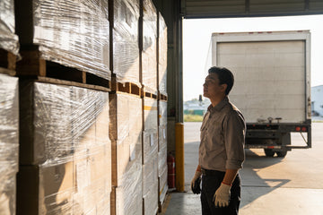 A shipping and receiving worker at an open loading dock door