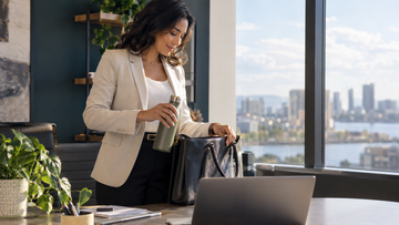 Busy professional organizing a work bag between meetings
