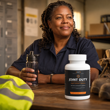 Experienced woman warehouse worker holding XGRITX JOINT DUTY joint support capsules after a shift