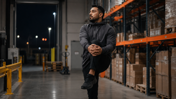 Warehouse worker warming up before a physical shift