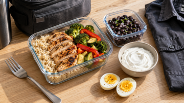 A balanced workday meal with chicken, beans, eggs and yogurt packed beside a worker's lunch bag.