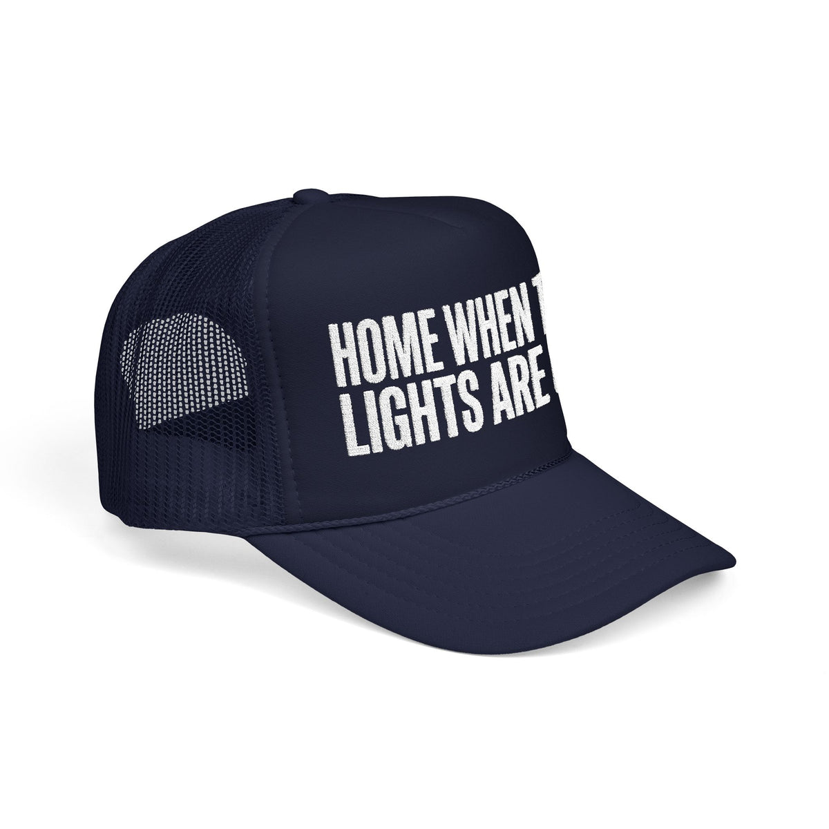 Dark navy Home When The Lights Are On trucker hat at three-quarter angle, mesh back panel and pre-curved visor visible.