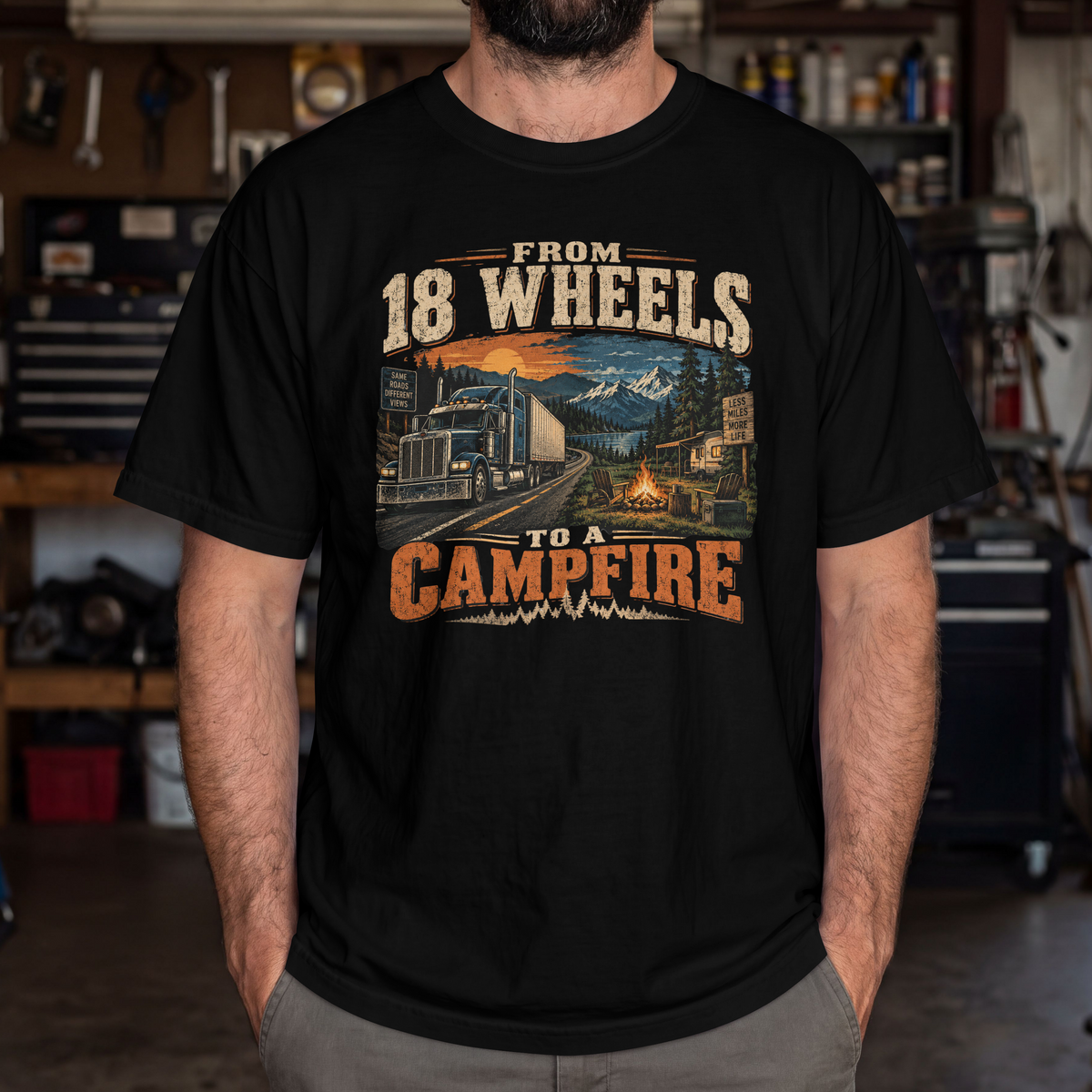 Black From 18 Wheels to a Campfire T-shirt worn by a model in a workshop, showing the front camping and semi-truck graphic.
