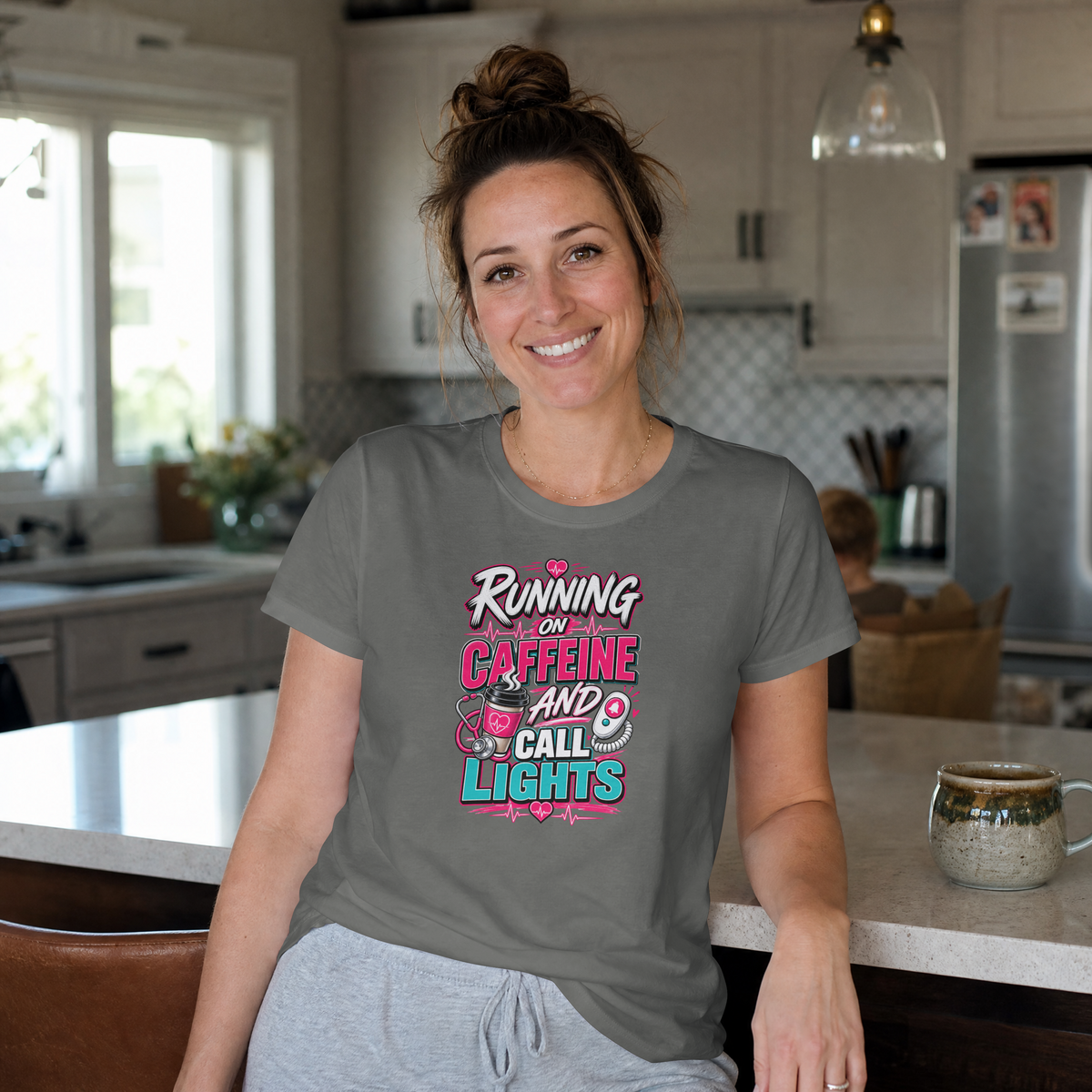 Nurse wearing the grey Running on Caffeine and Call Lights tee in a kitchen
