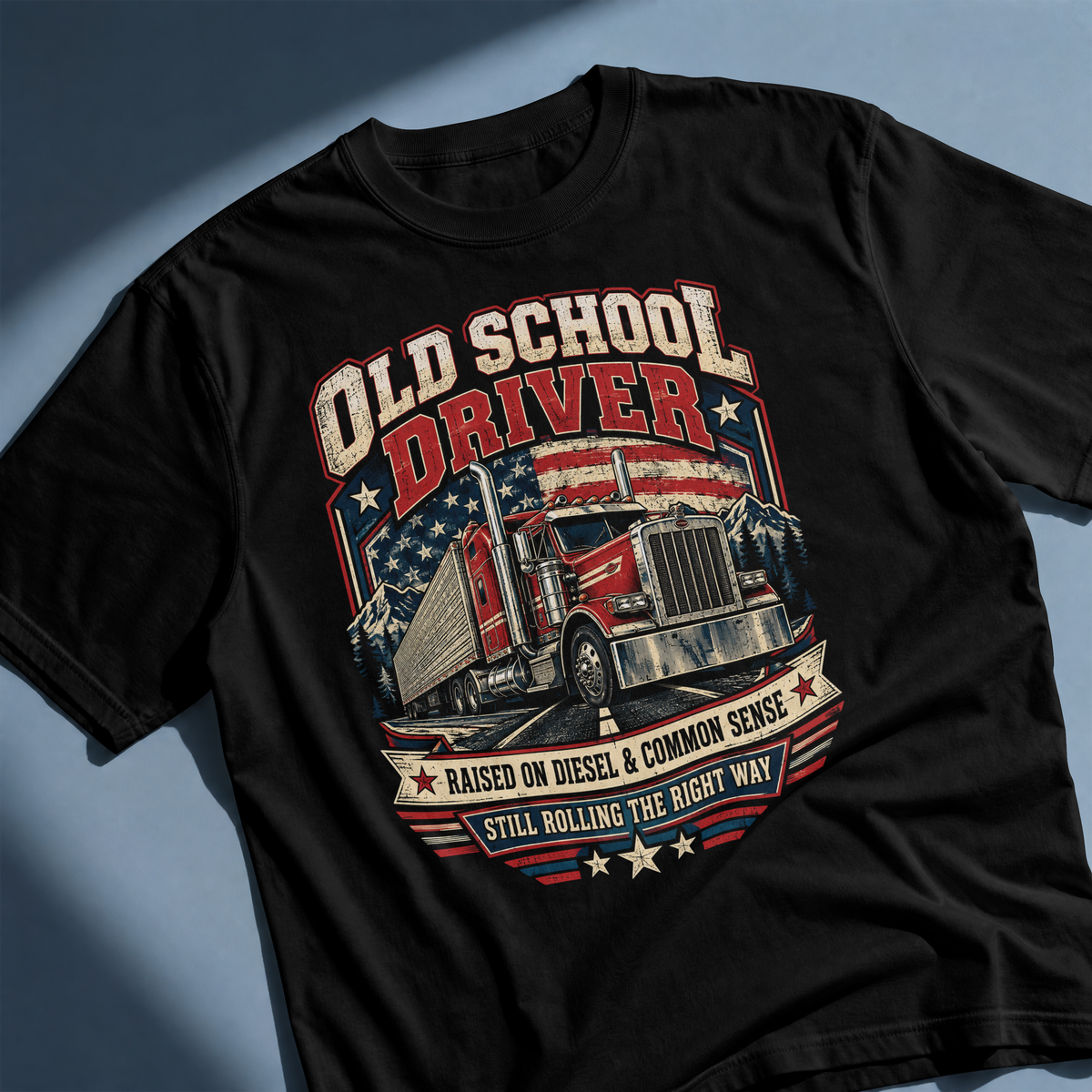 Black Old School Driver T-shirt laid flat at an angle, showing the complete semi-truck and American flag artwork.