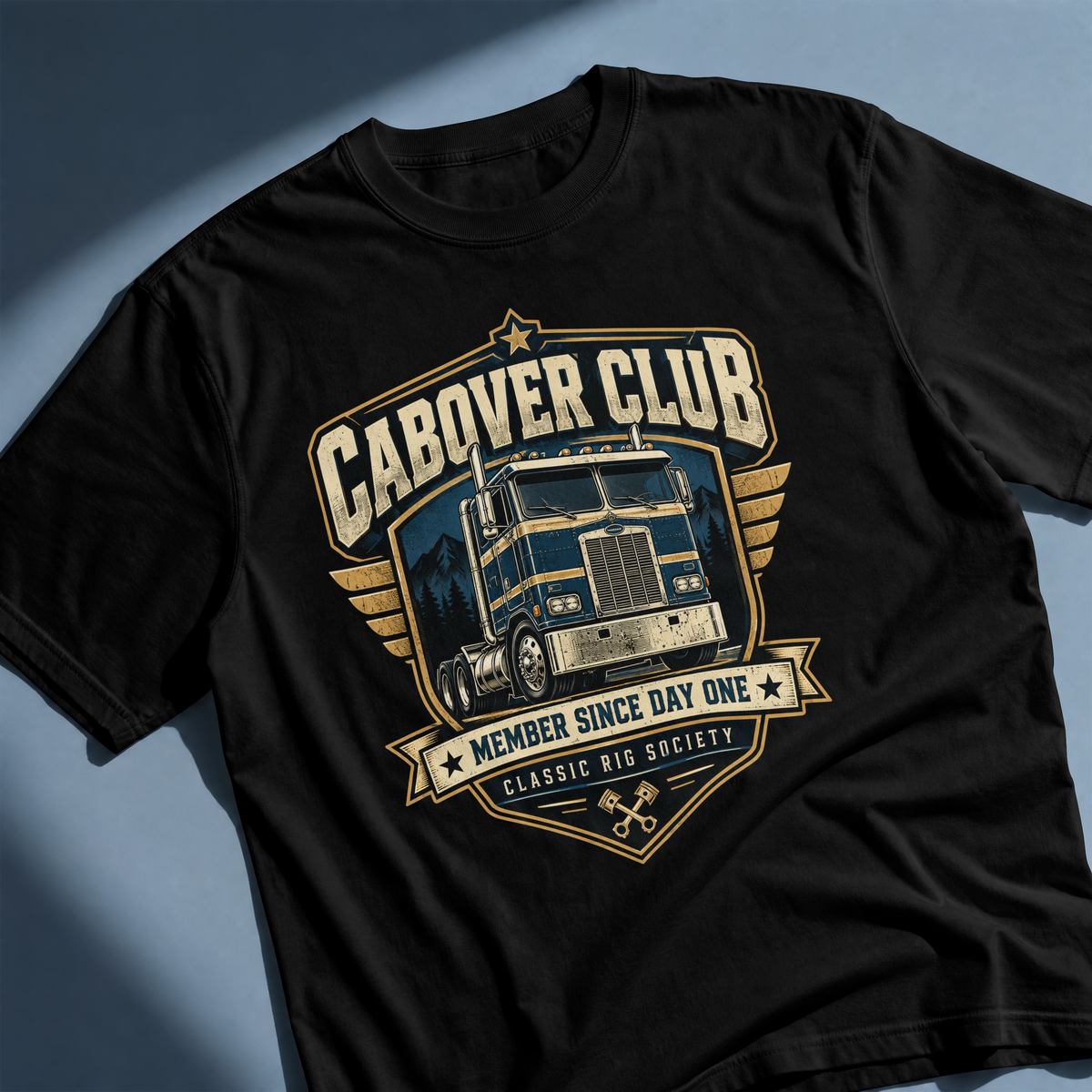 Black Cabover Club T-shirt with blue and gold vintage cabover truck graphic and Member Since Day One lettering, angled front detail.