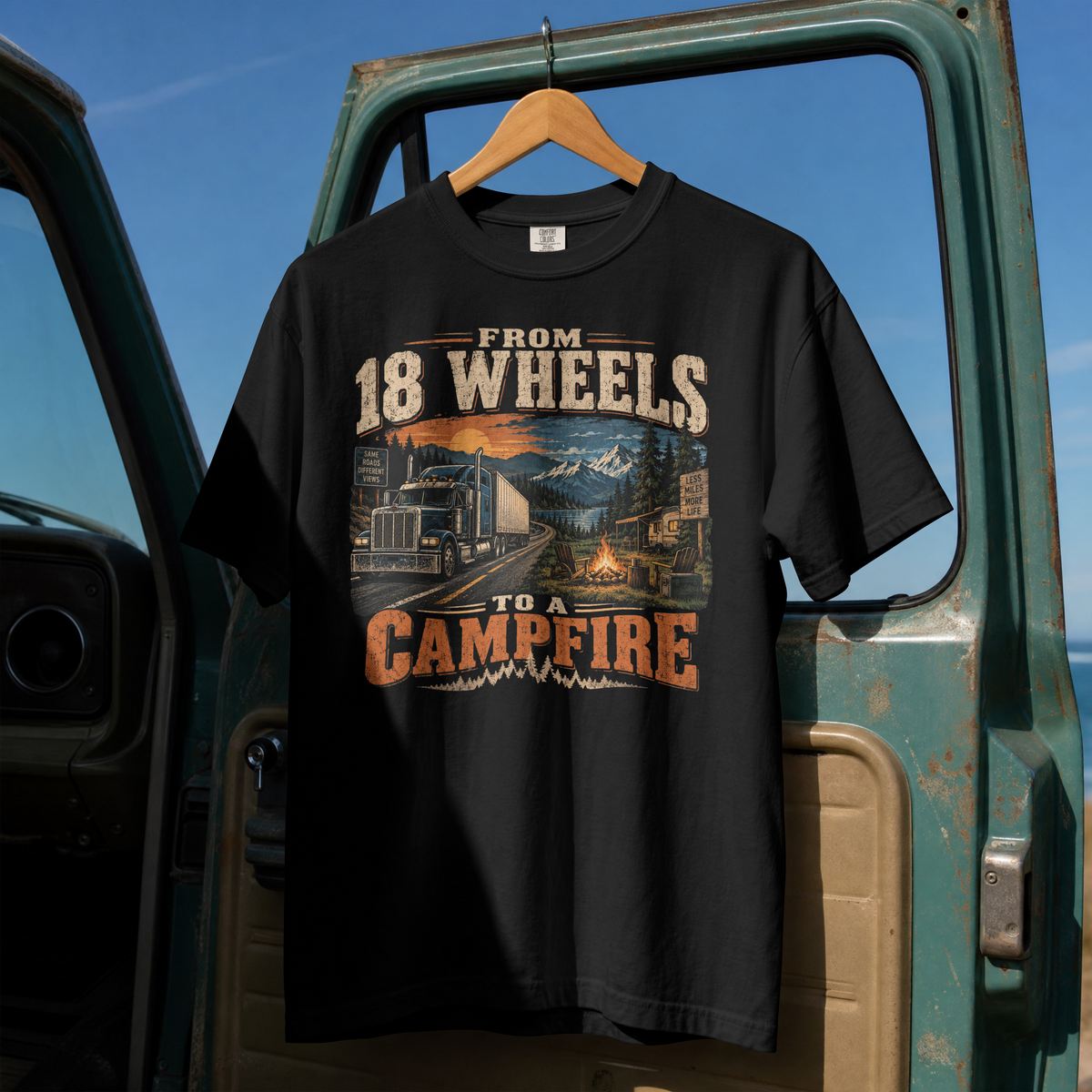 Black From 18 Wheels to a Campfire T-shirt, full front view on a hanger with semi-truck, lake and campfire graphic.