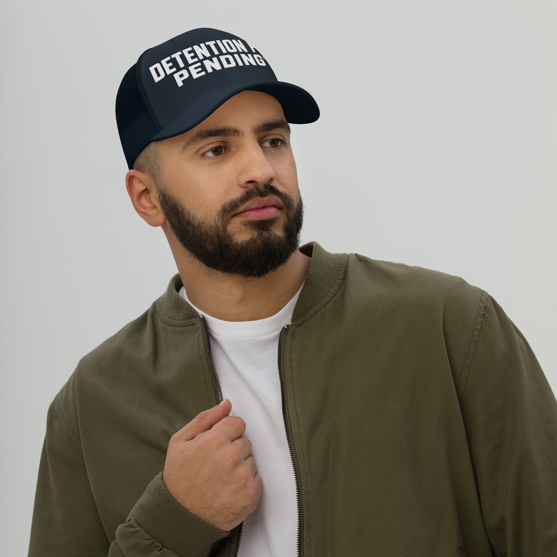 Detention Pay Pending embroidered trucker hat in navy, front view