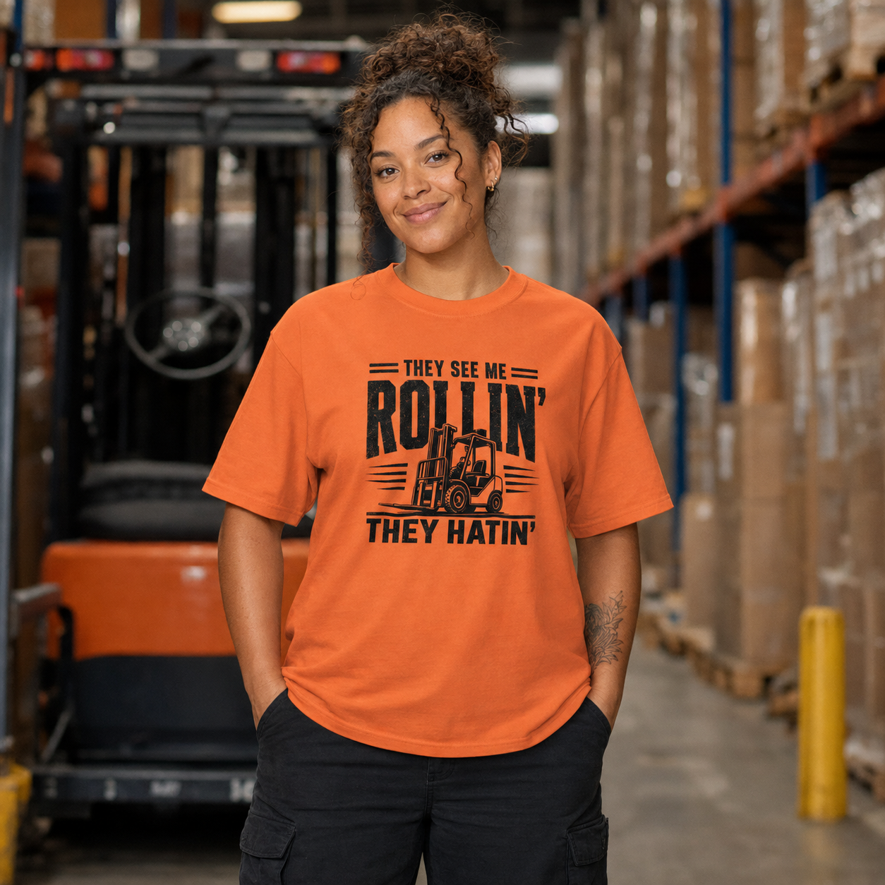 Woman forklift operator wearing They See Me Rollin They Hatin heavyweight warehouse T-shirt