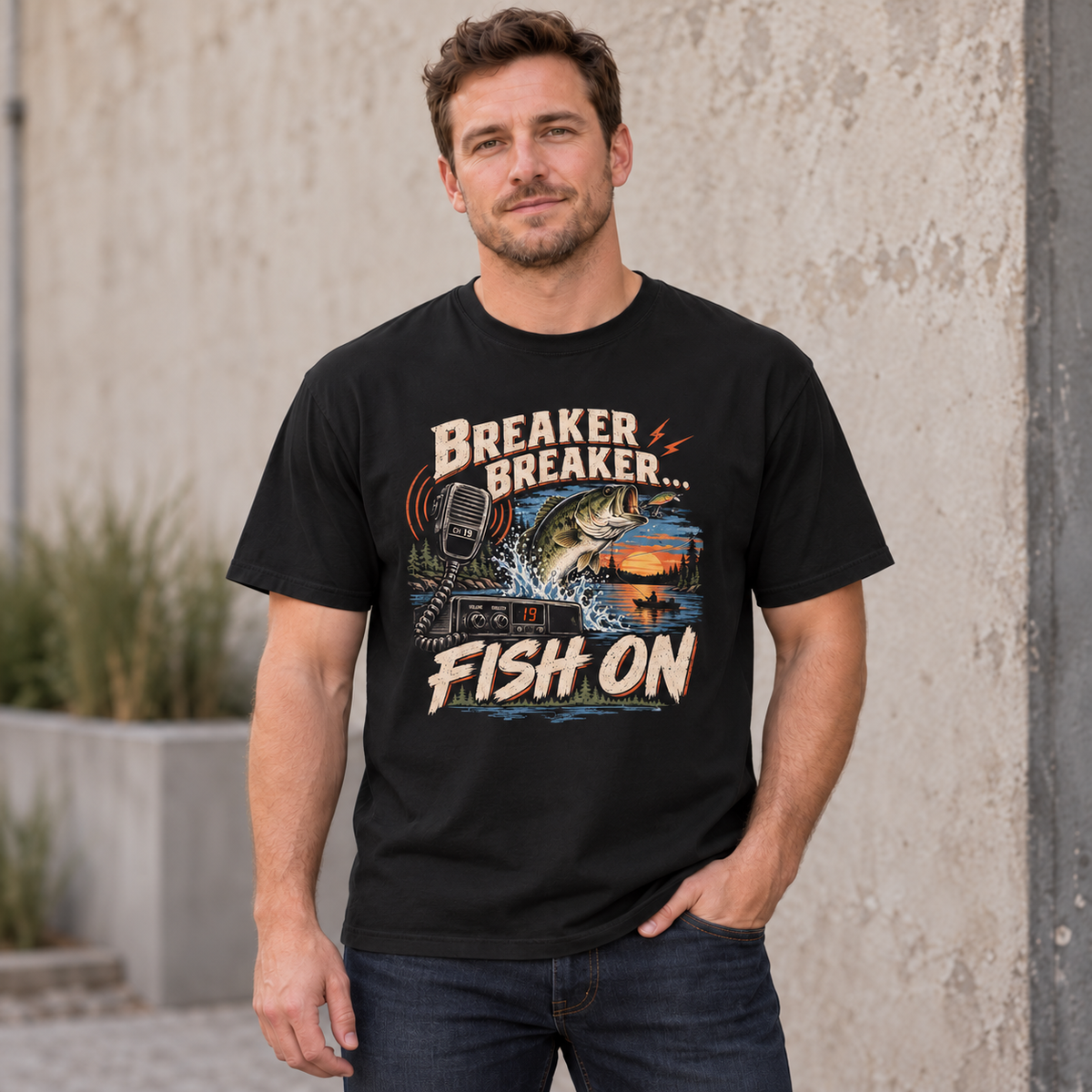 AI lifestyle mockup of the Black Breaker Breaker Fish On T-shirt worn by a model, showing the bass fishing and CB radio front graphic.