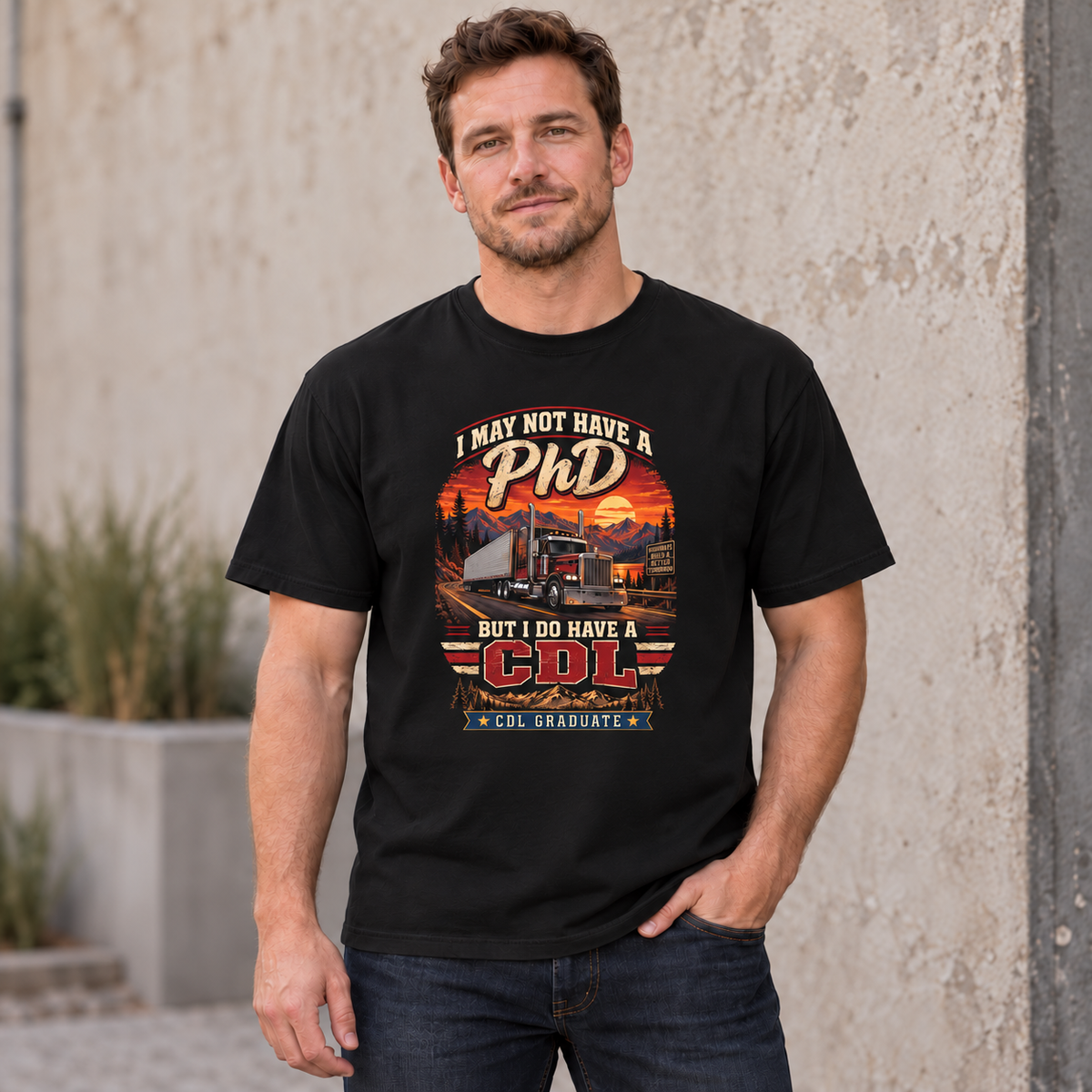 AI lifestyle mockup of a male model wearing a Black CDL Graduate T-shirt with I May Not Have a PhD But I Do Have a CDL lettering, a red semi-truck and mountain-road sunset.