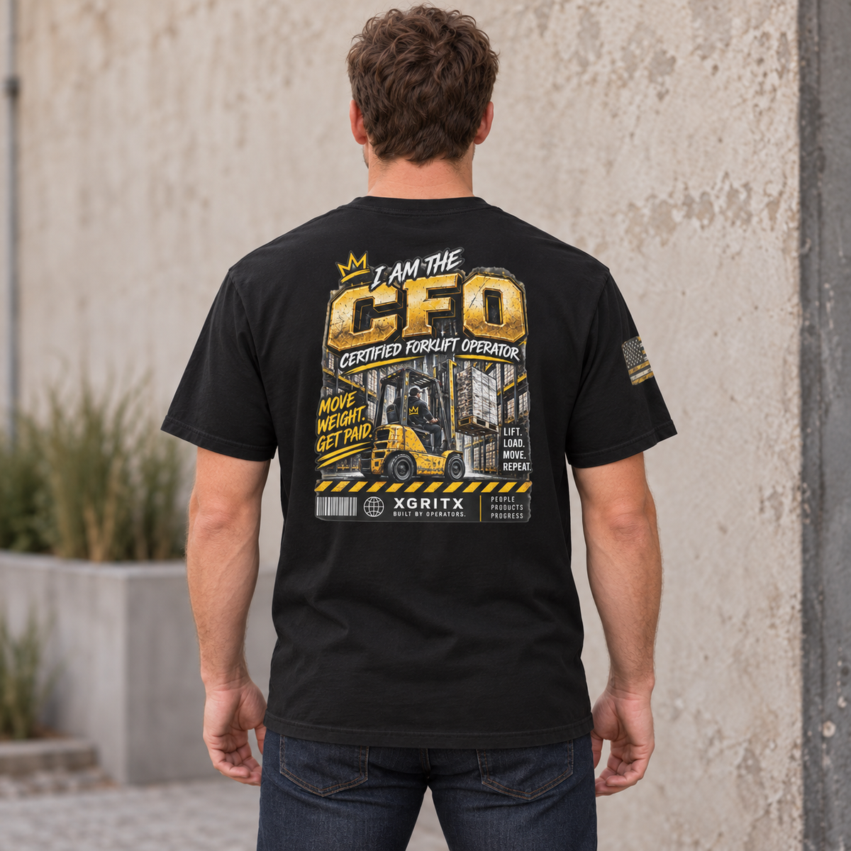 AI rear three-quarter lifestyle mockup of the Black CFO Certified Forklift Operator Flag Sleeve T-shirt, showing the large back graphic and sleeve flag.