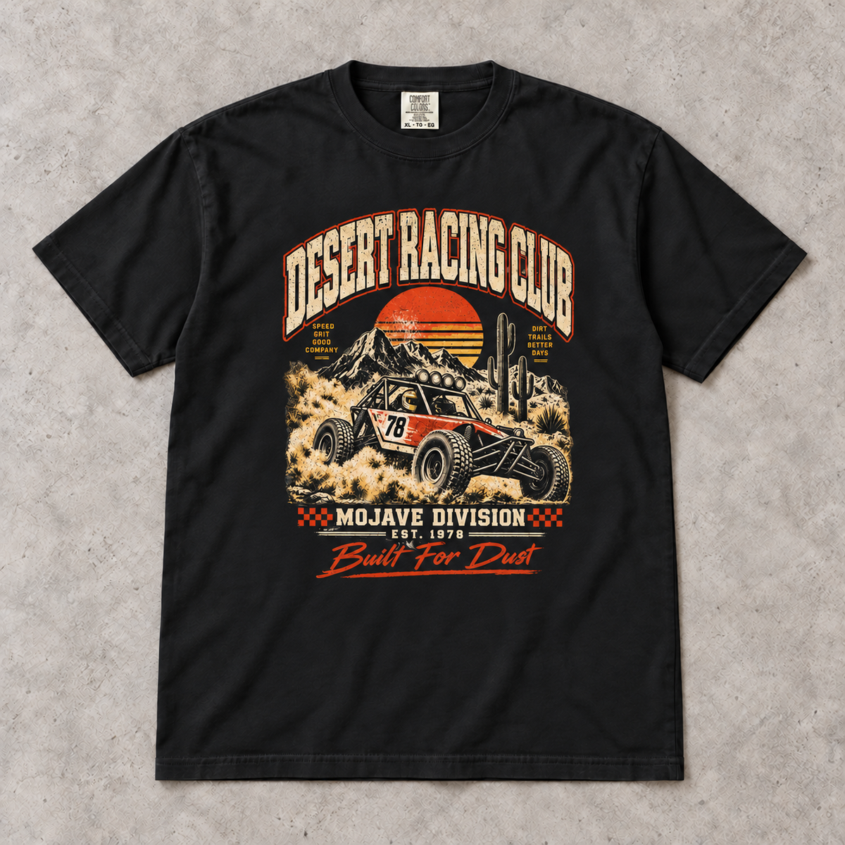 AI flat-lay mockup of the Black Desert Racing Club Mojave Division T-shirt with the Built For Dust buggy graphic.