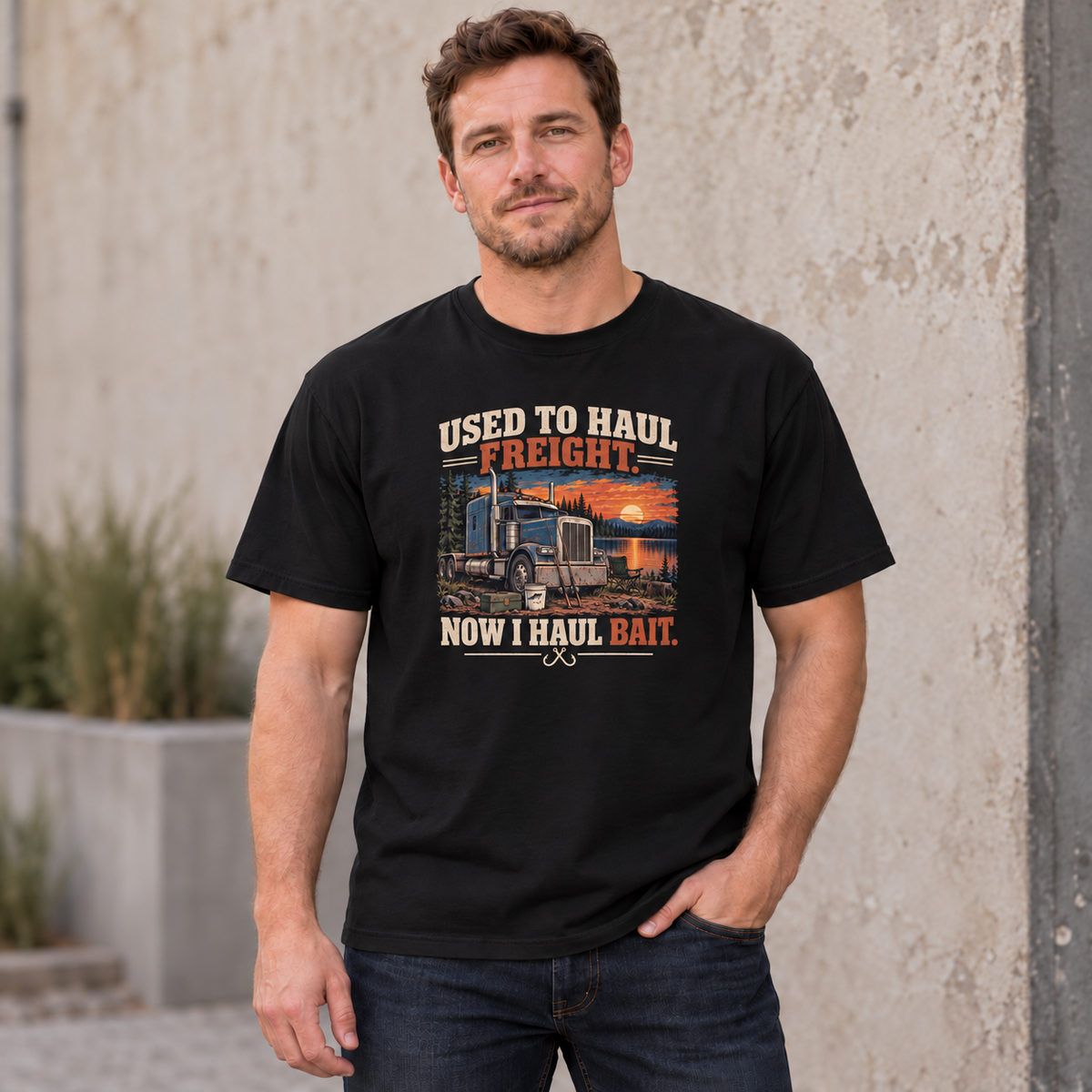 AI lifestyle mockup of a Black Used to Haul Freight Now I Haul Bait T-shirt worn by a male model, showing the truck, lakeside fishing scene and cream-and-orange lettering.
